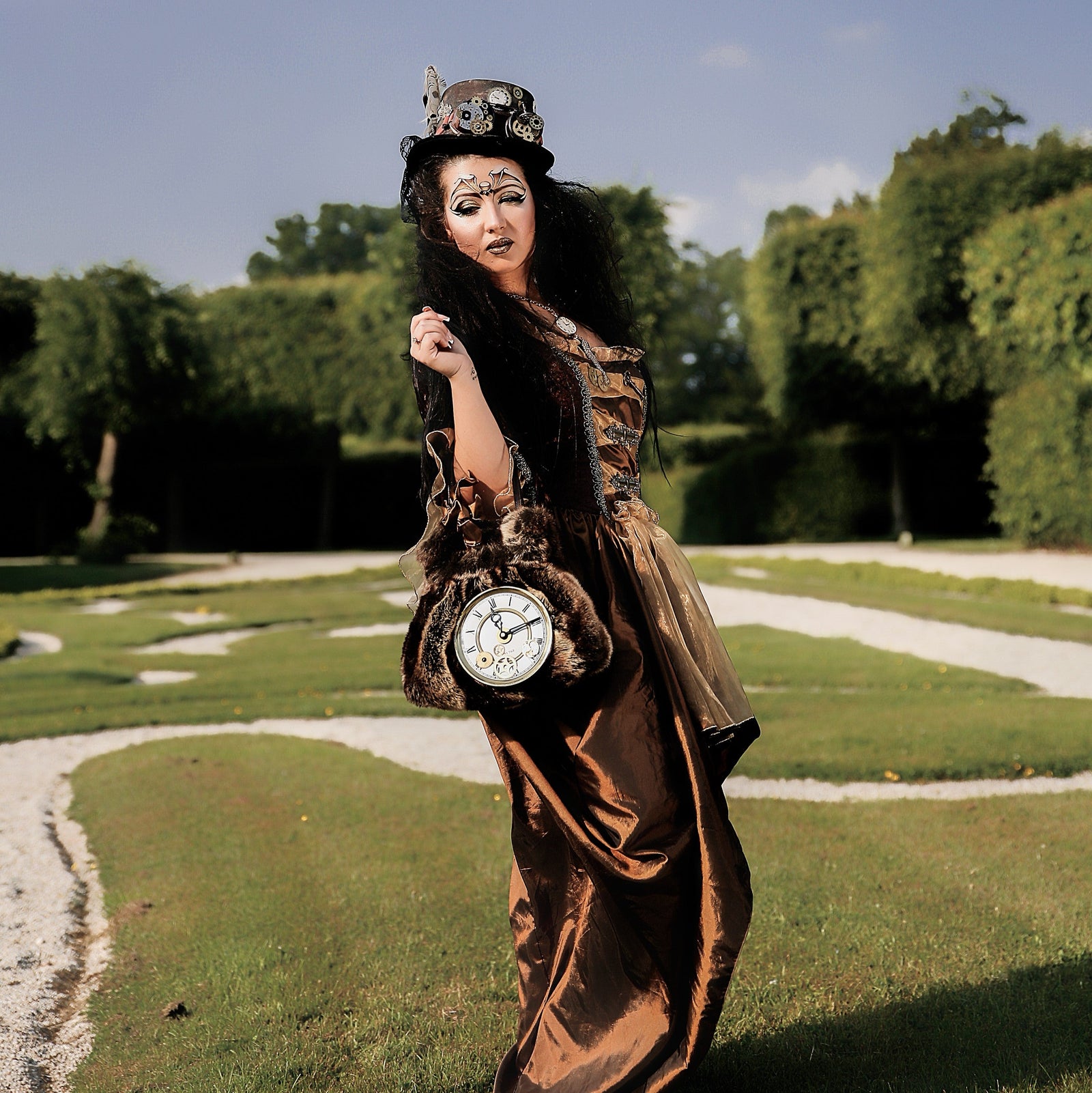 „Steampunk Damenkostüm – langes braunes Kleid mit veredelten Details, passender Zylinder und Handtasche mit großer Uhr im viktorianischen Vintage-Stil“
