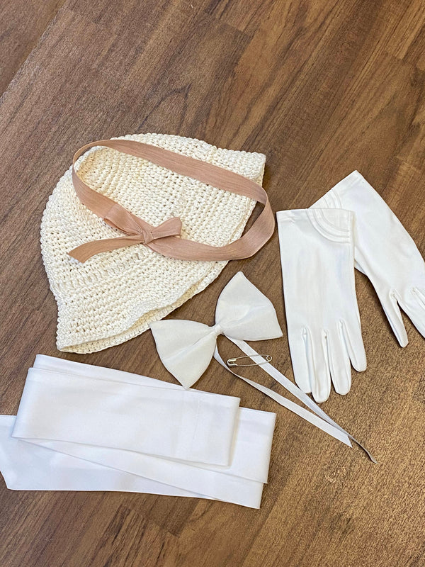 „Accessoires zum Oldtimer-Fahrt Outfit mit hellem Hut, weißen Handschuhen und weißem Taillenband“