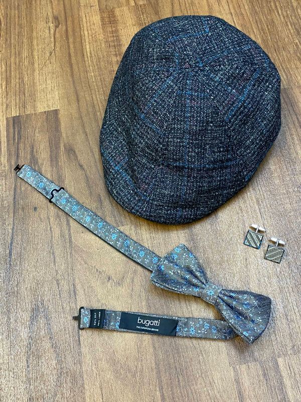 Schiebermütze, Fliege und Manschettenknöpfe als Accessoires für Vintage Herren Outfit