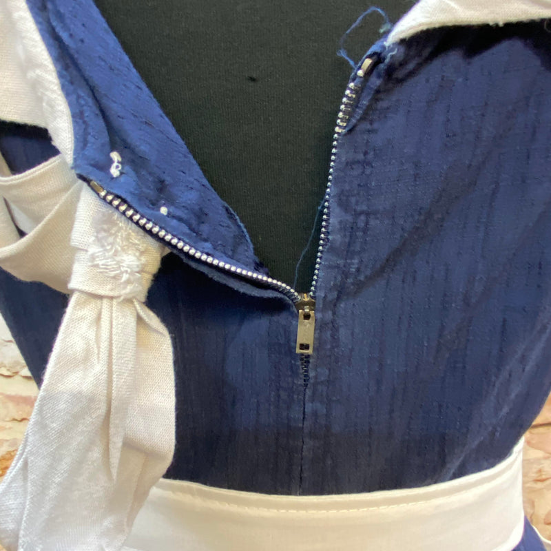 „Detailansicht vom Rücken des 50er Jahre Vintage Kleides mit Schleife, Gürtel und Metallreißverschluss“
