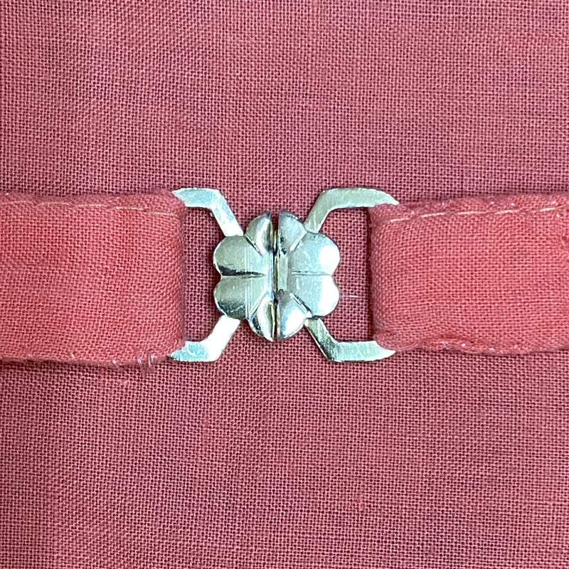 „Dirndlschürze mit Metallschließe Vintage Trachtenmode Detailverschluss“
