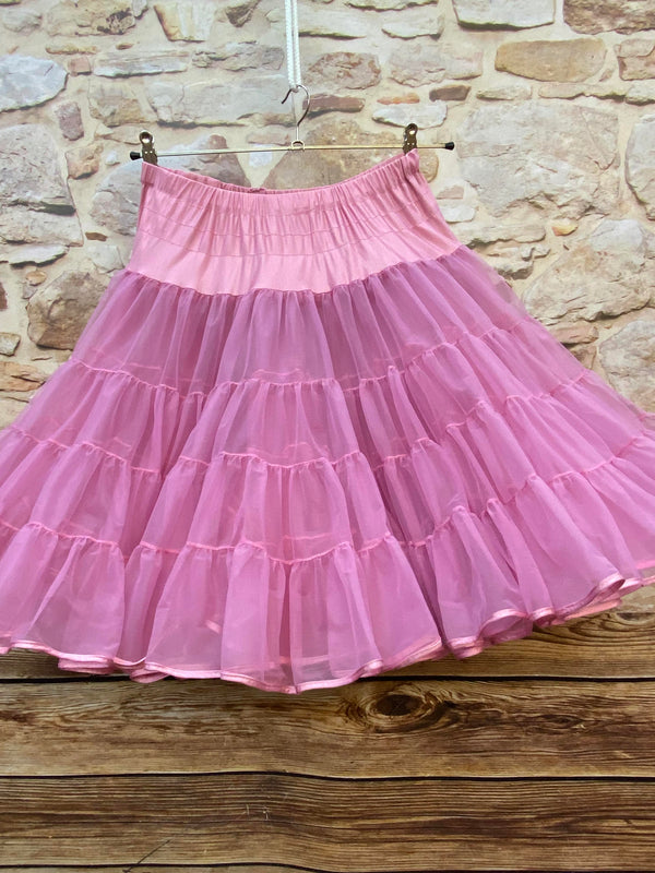 „Rosa Vintage-Petticoat hängend vor Steinwand, füllige Stufen aus Tüll, elastischer Bund“