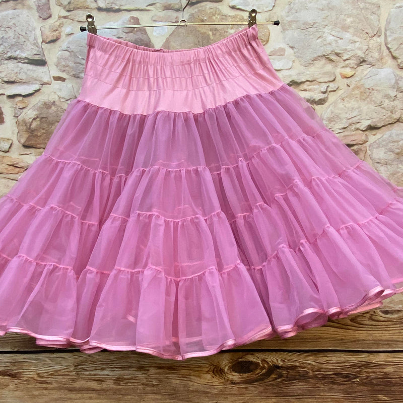 „Rosa Vintage-Petticoat hängend vor Steinwand, füllige Stufen aus Tüll, elastischer Bund“