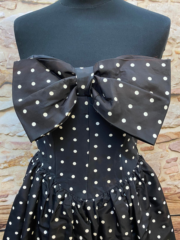 „Detailansicht vom schwarzen Polka Dot Bandeaukleid mit großer Schleife im Rockabilly Style“