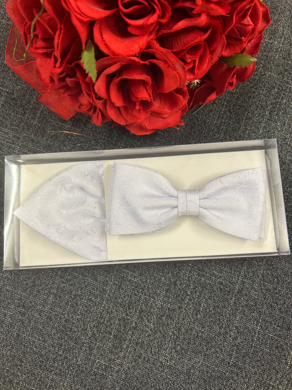 Weißes Fliegen- und Einstecktuch-Set in Geschenkbox mit roten Rosen im Hintergrund