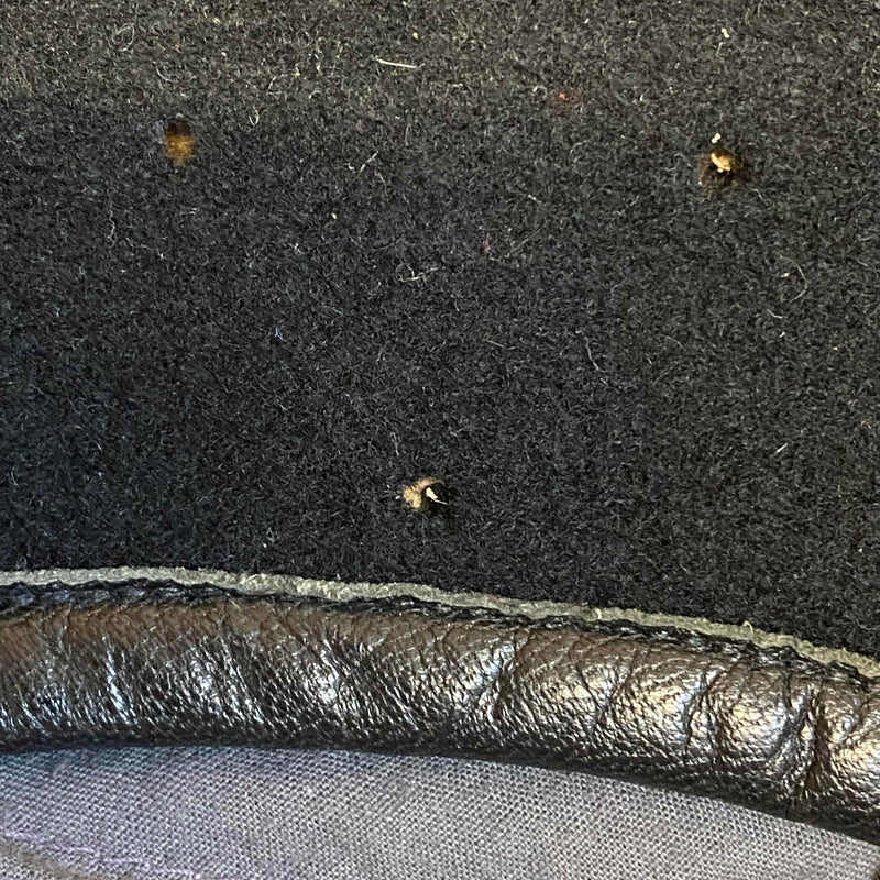 „Detailaufnahme vom schwarzen Vintage Uniform-Barett mit kleinen Spuren einer ehemaligen Abzeichenbefestigung“