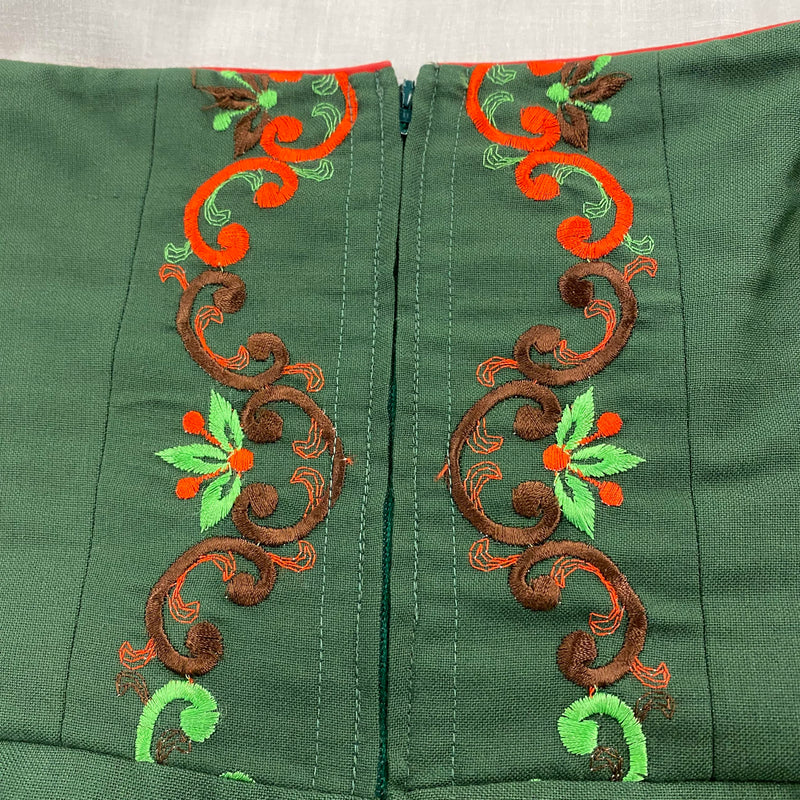 Besticktes Mieder des grünen Vintage Dirndls mit Reißverschluss und roter Paspelierung
