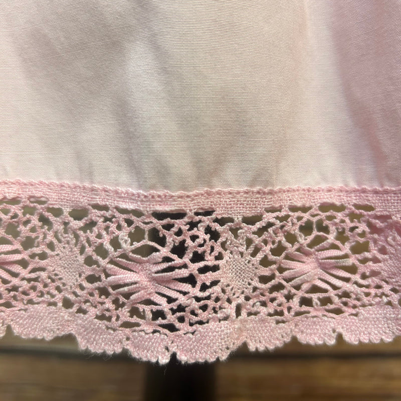 „Detailansicht Bund und Spitzen-Saum der rosa Vintage Dirndl-Schürze“