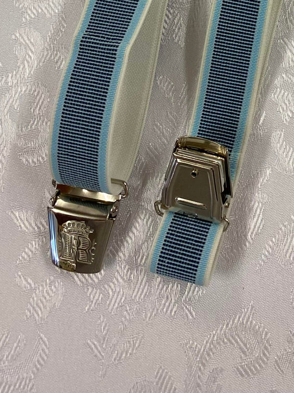 „Detailaufnahme hellblau gestreifte Hosenträger mit dekorativem Monogramm-Clip“