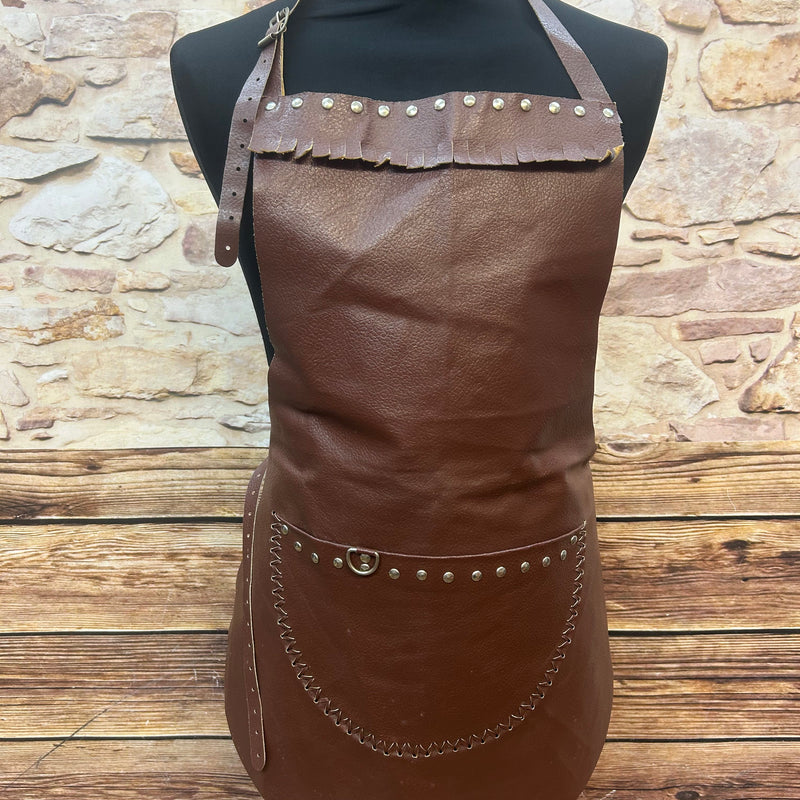 Vorderansicht einer braunen vintage Lederschürze mit Tasche, Nieten und Riemen.
