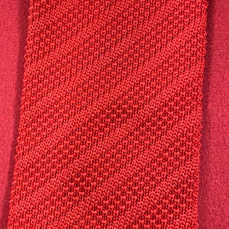 „Detailaufnahme rote Strickkrawatte mit feiner Struktur im Retro Stil“