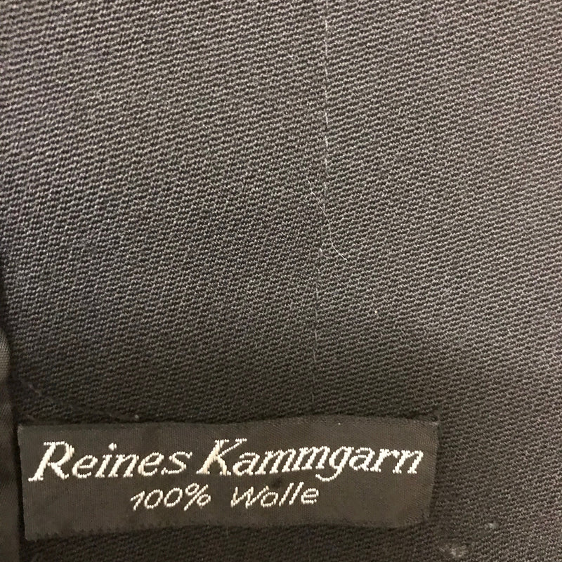 Etikett „Reines Kammgarn 100 % Wolle“ an schwarzer Vintage Damenjacke